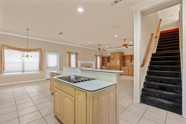 kitchen featuring black electric stovetop, a center island, light tile patterned floors, and decorative light fixtures