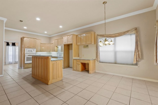 kitchen with a center island, hanging light fixtures, white appliances, light brown cabinets, and light tile patterned floors