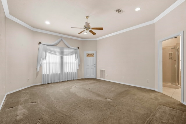 carpeted spare room featuring ceiling fan and crown molding