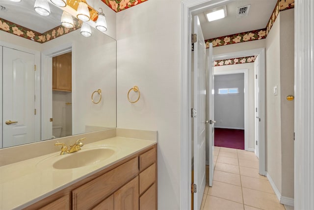 bathroom featuring tile patterned floors, vanity, and toilet