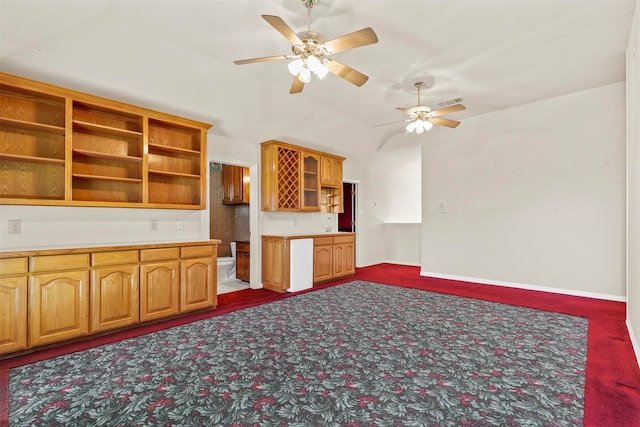 kitchen with ceiling fan and dark colored carpet