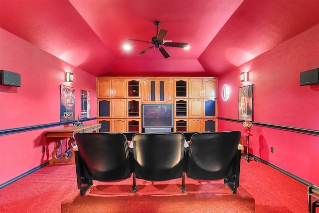 home theater with a textured ceiling, lofted ceiling, light carpet, and ceiling fan