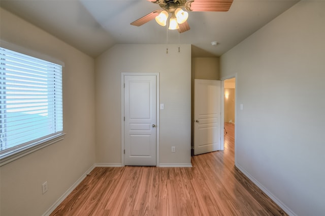 unfurnished bedroom featuring light wood-type flooring, ceiling fan, and lofted ceiling