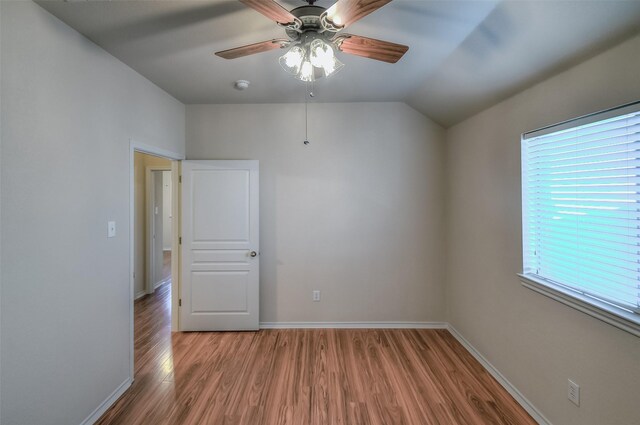 empty room featuring hardwood / wood-style flooring, a wealth of natural light, and ceiling fan