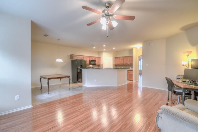 living room featuring light wood-type flooring and ceiling fan