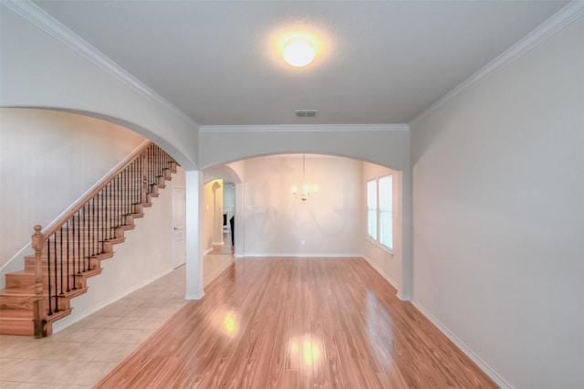 9816 Mullins Crossing Dr, Fort Worth, TX 76126 - unfurnished room featuring crown molding, wood finished floors, stairway, a chandelier, and arched walkways