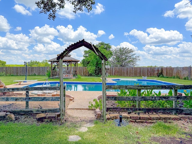 view of swimming pool with a gazebo, a diving board, and a yard