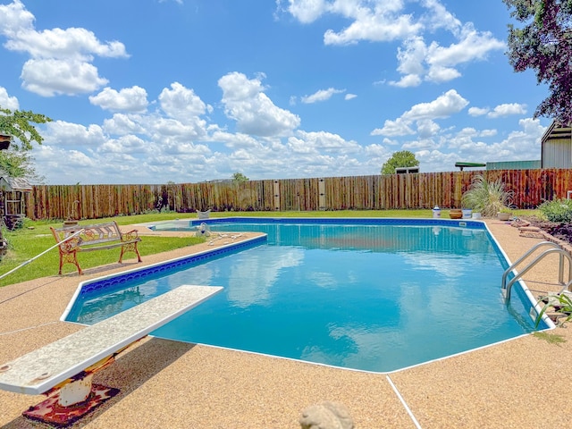 view of pool featuring a patio area and a diving board