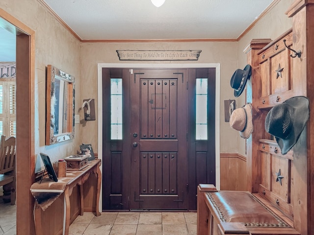 entryway featuring ornamental molding and light tile patterned flooring