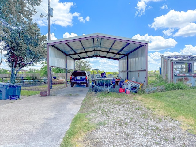 view of parking / parking lot with a lawn and a carport