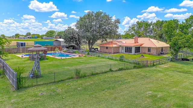 view of yard featuring a fenced in pool and a gazebo