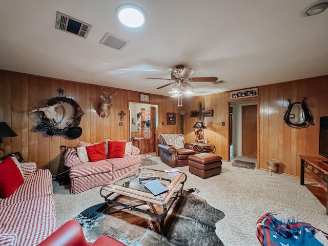 living room featuring ceiling fan, carpet floors, and wooden walls