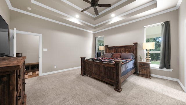 carpeted bedroom with crown molding, a raised ceiling, and ceiling fan