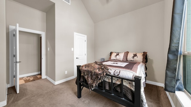 carpeted bedroom featuring high vaulted ceiling