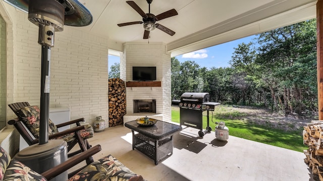 view of patio featuring an outdoor fireplace, a grill, and ceiling fan