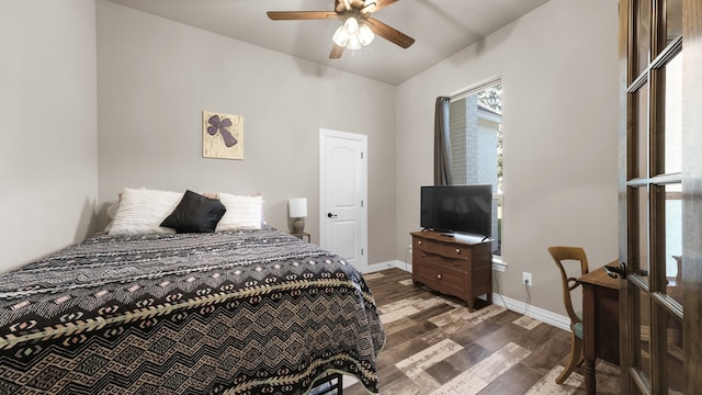 bedroom with dark hardwood / wood-style floors and ceiling fan