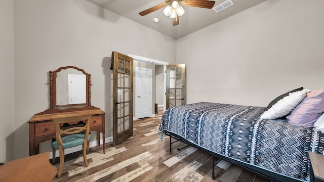 bedroom with french doors, ceiling fan, and hardwood / wood-style floors