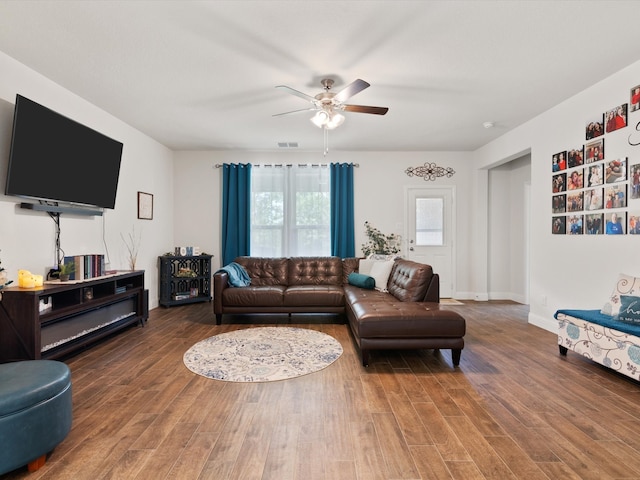 living room with ceiling fan and dark hardwood / wood-style floors