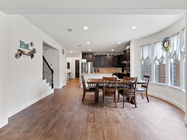 dining space featuring sink and hardwood / wood-style floors