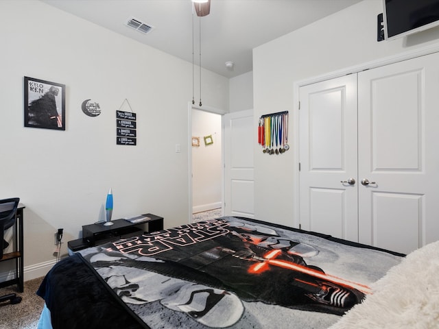 carpeted bedroom featuring a closet and ceiling fan