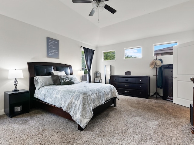 carpeted bedroom featuring lofted ceiling and ceiling fan