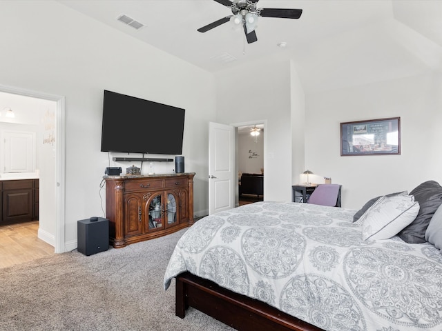 carpeted bedroom featuring ceiling fan and ensuite bath