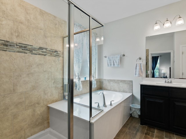 bathroom with vanity, independent shower and bath, and hardwood / wood-style floors