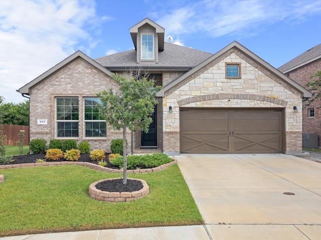 view of front of property featuring a front lawn and a garage