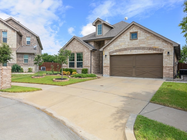 view of front of house with a front yard and a garage