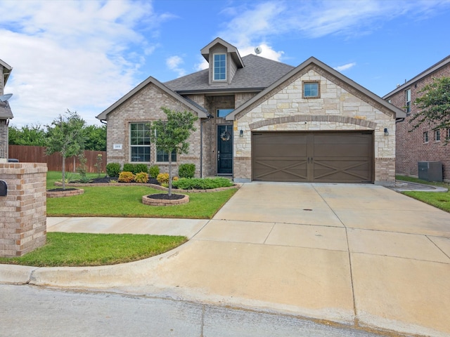 view of front of property featuring a front lawn and a garage