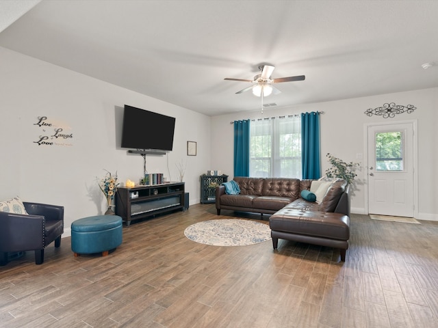 living room with ceiling fan and wood-type flooring