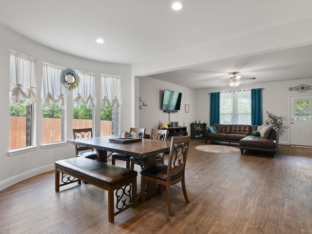 dining area with ceiling fan and dark hardwood / wood-style flooring