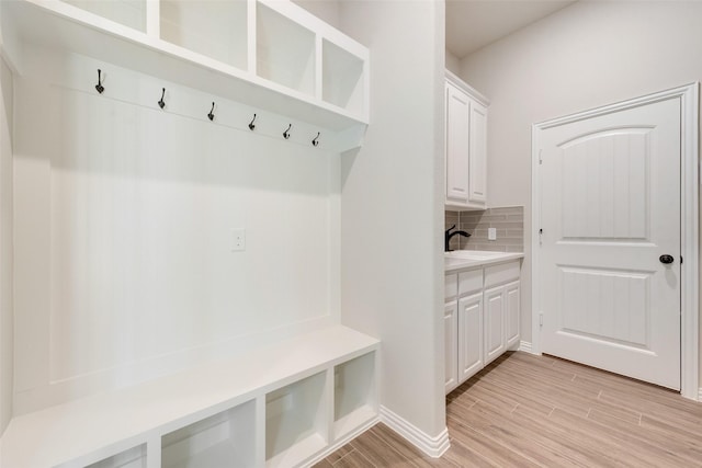 mudroom featuring sink and light wood-type flooring