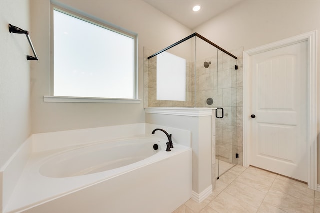 bathroom with tile patterned flooring and separate shower and tub