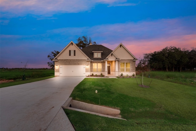 craftsman-style home featuring a garage and a yard