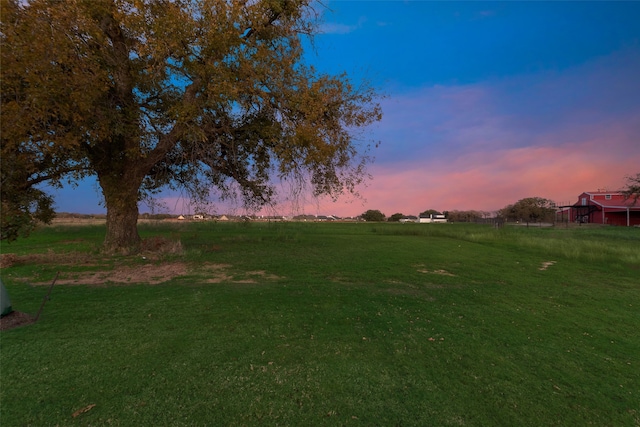 yard at dusk with a rural view