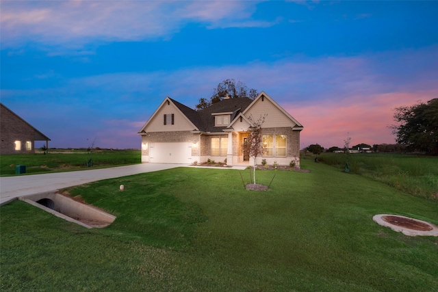 view of front of property featuring a garage and a lawn