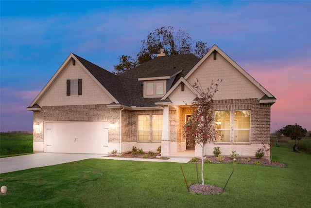 craftsman-style home featuring a garage and a yard