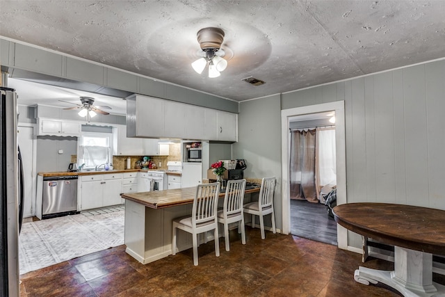 kitchen featuring stainless steel appliances, white cabinetry, sink, and ceiling fan