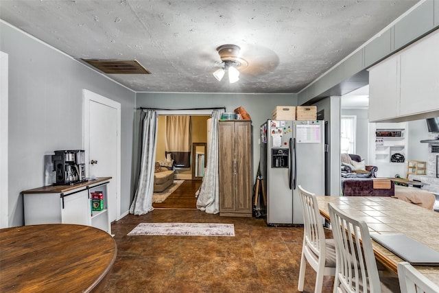 kitchen featuring white cabinetry, stainless steel fridge, and ceiling fan