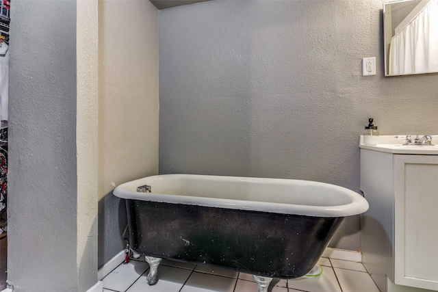 bathroom featuring tile patterned flooring, vanity, and a tub