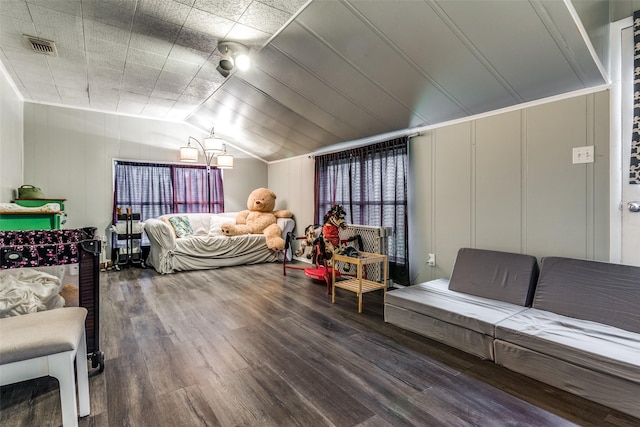 bedroom with vaulted ceiling and hardwood / wood-style floors