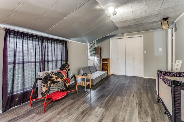 living area with wood-type flooring and lofted ceiling