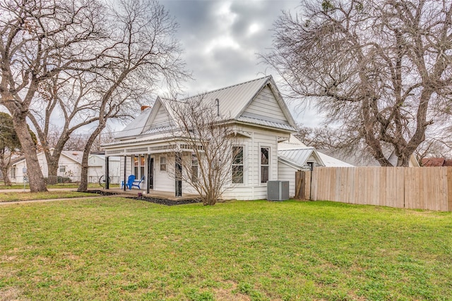 exterior space with a yard, a porch, and central AC