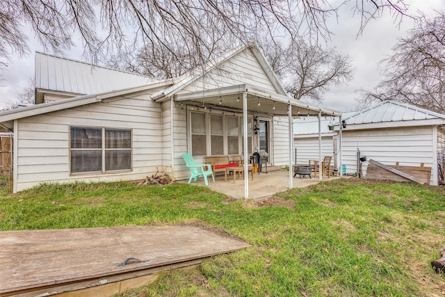 rear view of house featuring a yard and a patio area