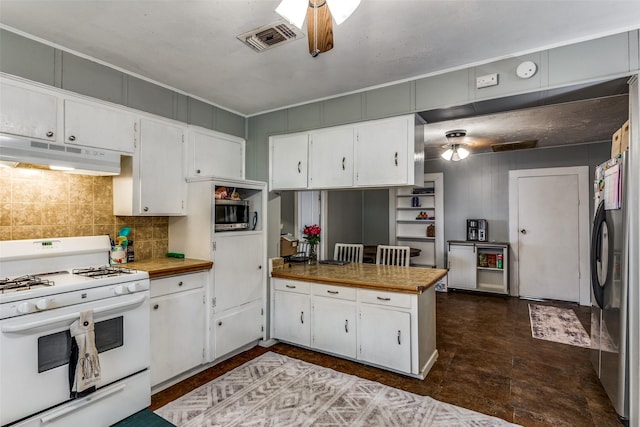 kitchen featuring white cabinets, backsplash, stainless steel refrigerator, and white range with gas stovetop