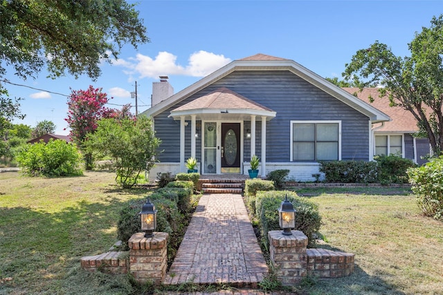 bungalow-style house with a front lawn