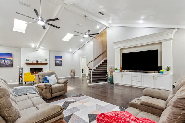 living room featuring ceiling fan, a fireplace, beamed ceiling, high vaulted ceiling, and dark hardwood / wood-style flooring