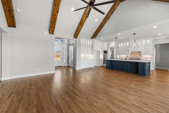 unfurnished living room featuring light hardwood / wood-style flooring, high vaulted ceiling, and beam ceiling