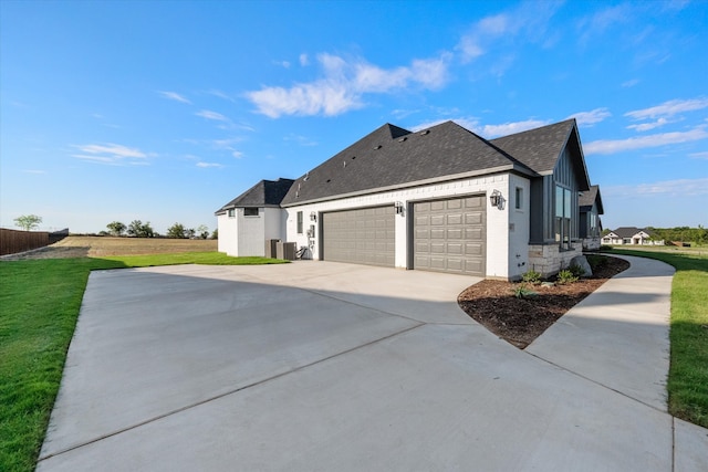 view of property exterior featuring a lawn and a garage